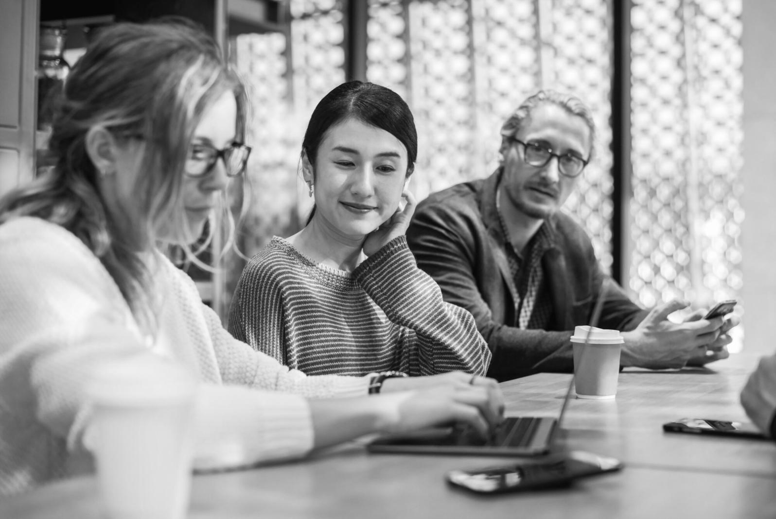 Financial professionals collaborating on strategic communication projects in modern workspace